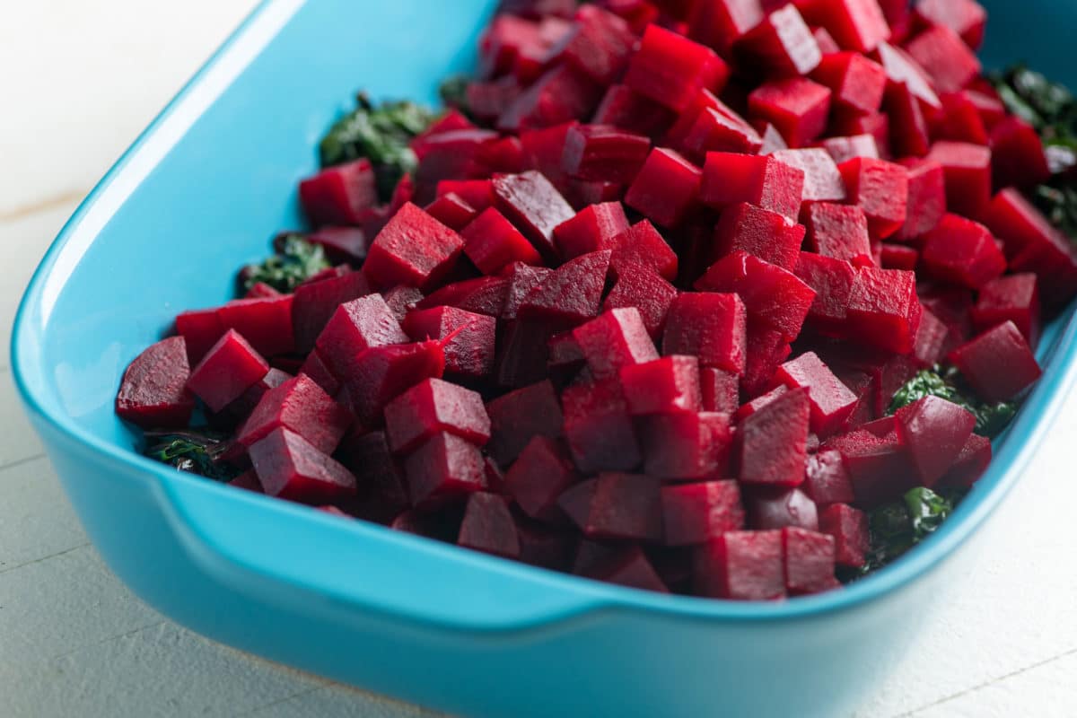 Beets and Sauteed Beet Greens in a blue baking dish.