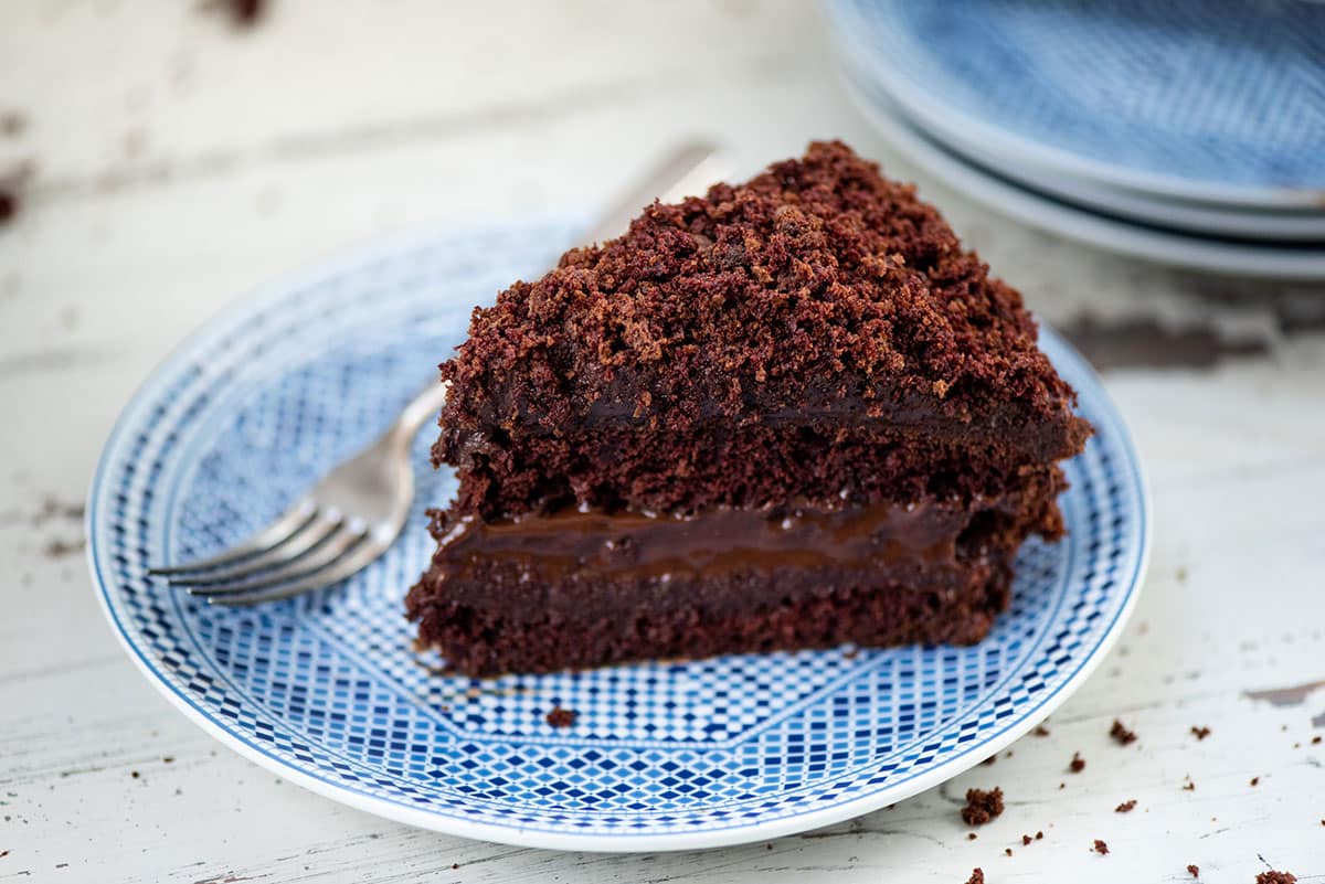 Slice of Ebinger’s Blackout Cake on a plate with a fork.