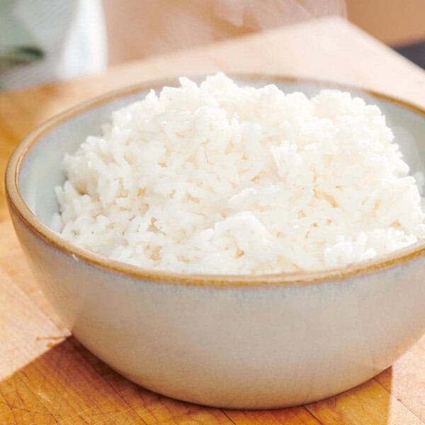 Cooked white rice in grey bowl on counter.