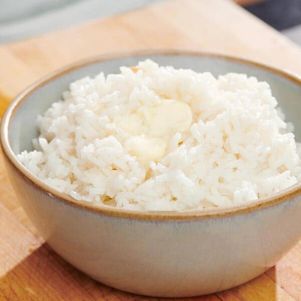 Plain cooked white rice in a light gray bowl.