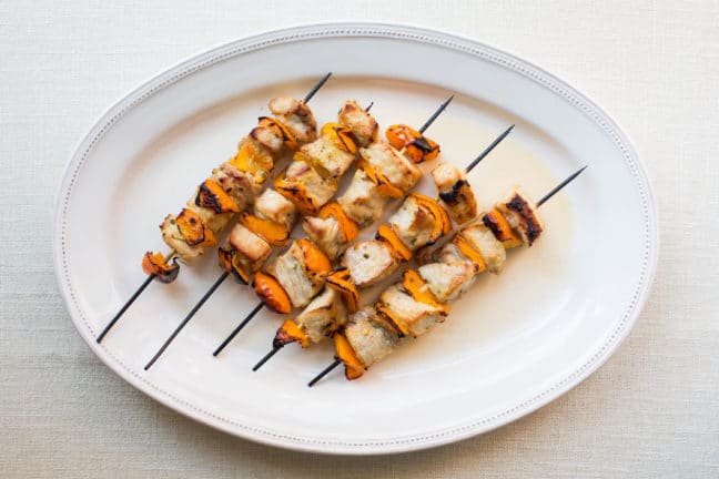 White serving platter of Mustard and Maple Pork Kebabs.