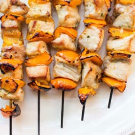 Mustard and Maple Pork Kabobs on white plate.