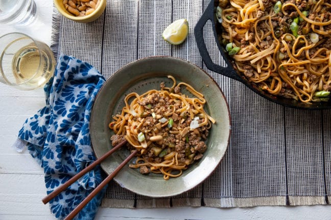 Skillet and plate of Dan Dan Noodles.