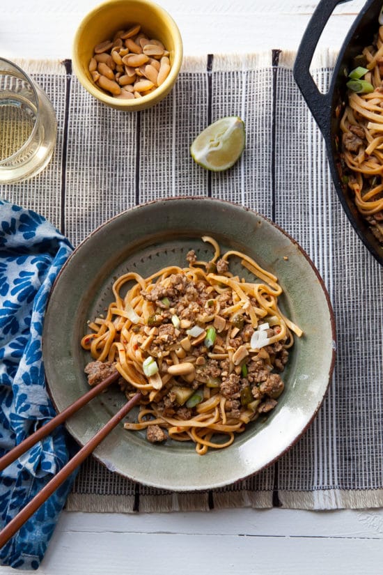 Dan Dan Noodles on a plate with chopsticks.