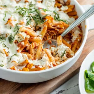 Pasta casserole with Bolognese sauce and mozzarella in dish.