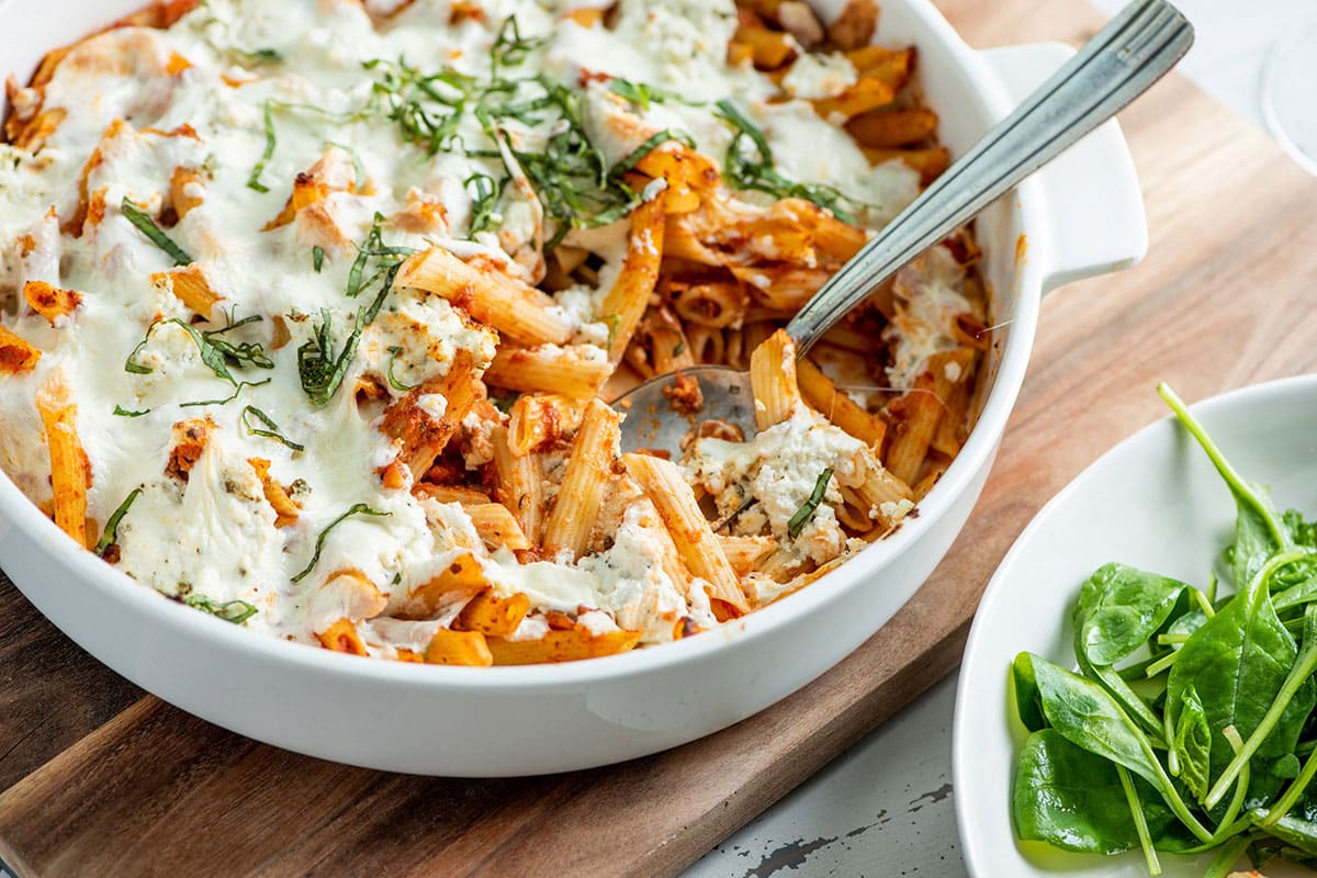 Pasta casserole with Bolognese sauce and mozzarella in dish.
