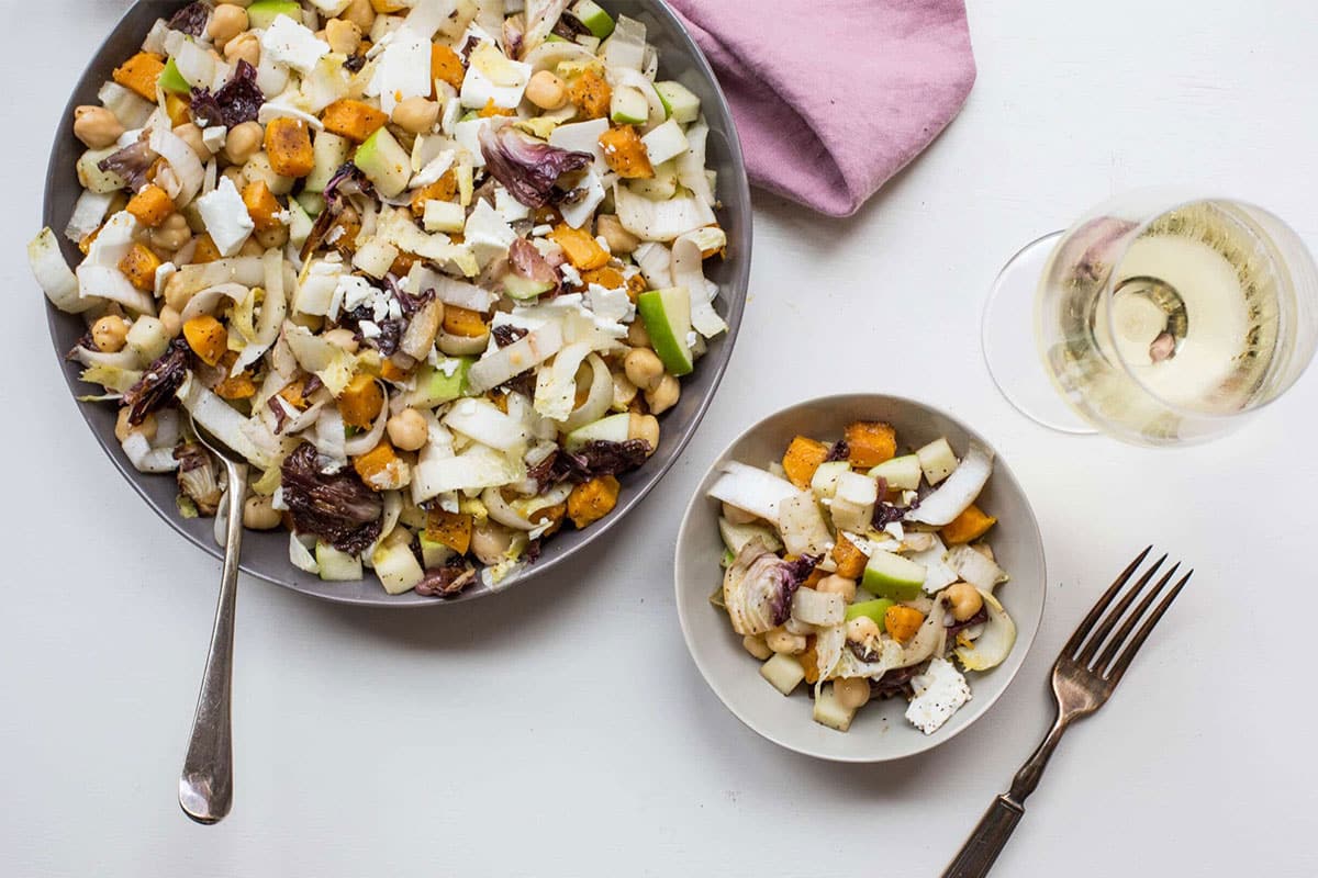Serving dish and bowl of chopped winter salad.