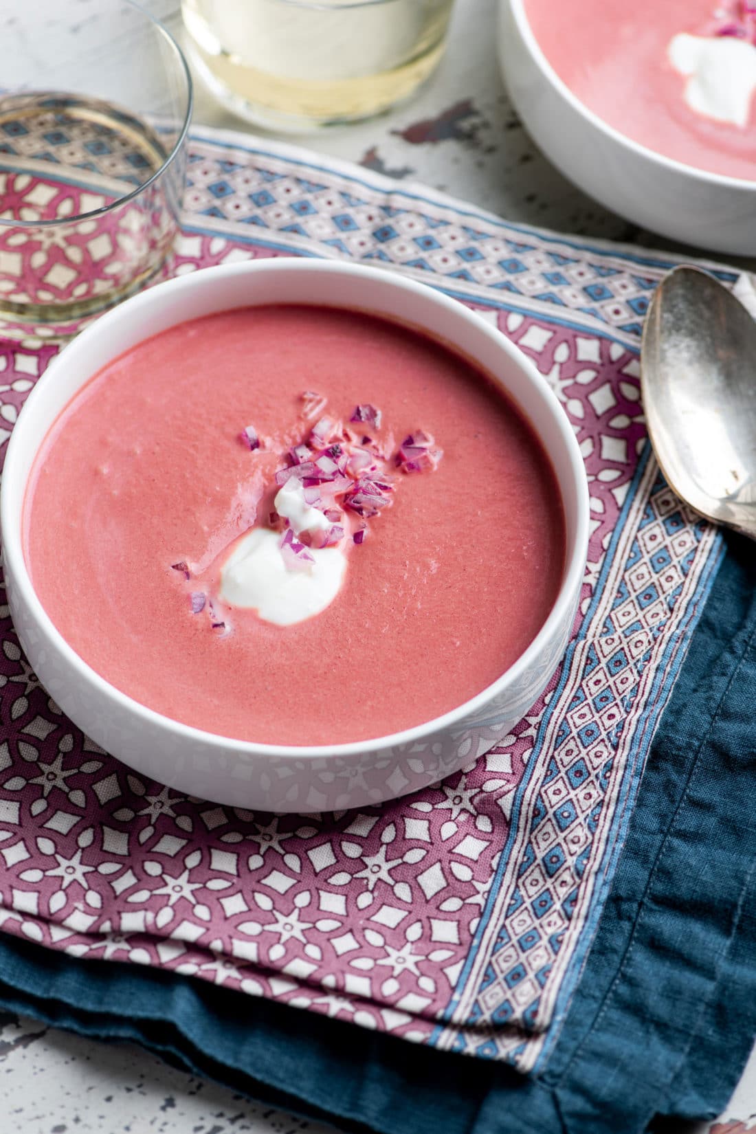 Bowl of Creamy Roasted Beet Soup on a cloth napkin.