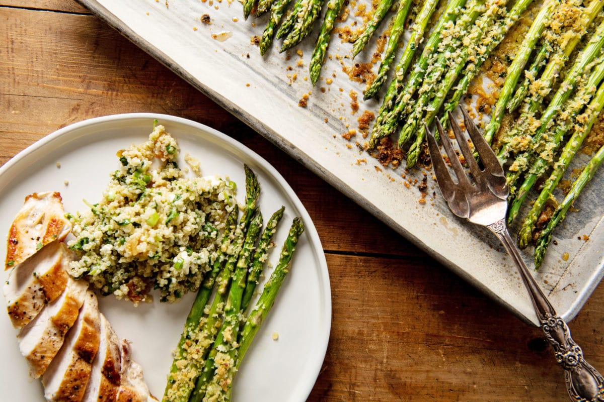 Garlicky Roasted Asparagus with Parmesan on a plate and a serving platter.