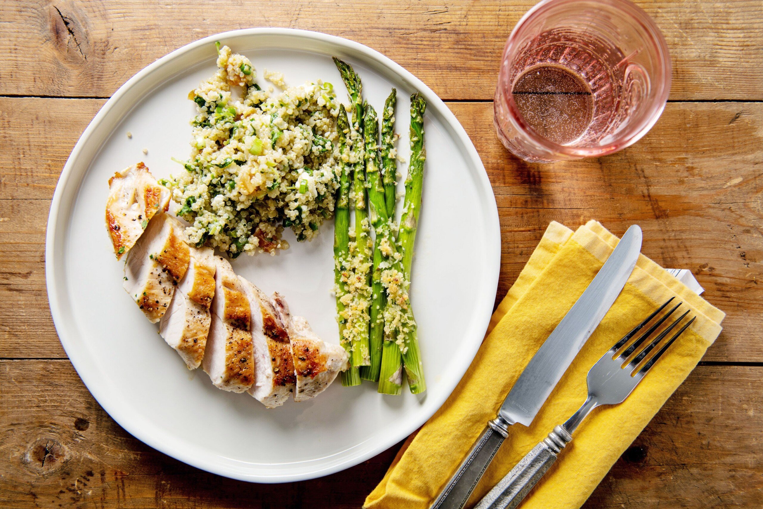 Garlicky Roasted Asparagus with Parmesan on plate with chicken and rice.