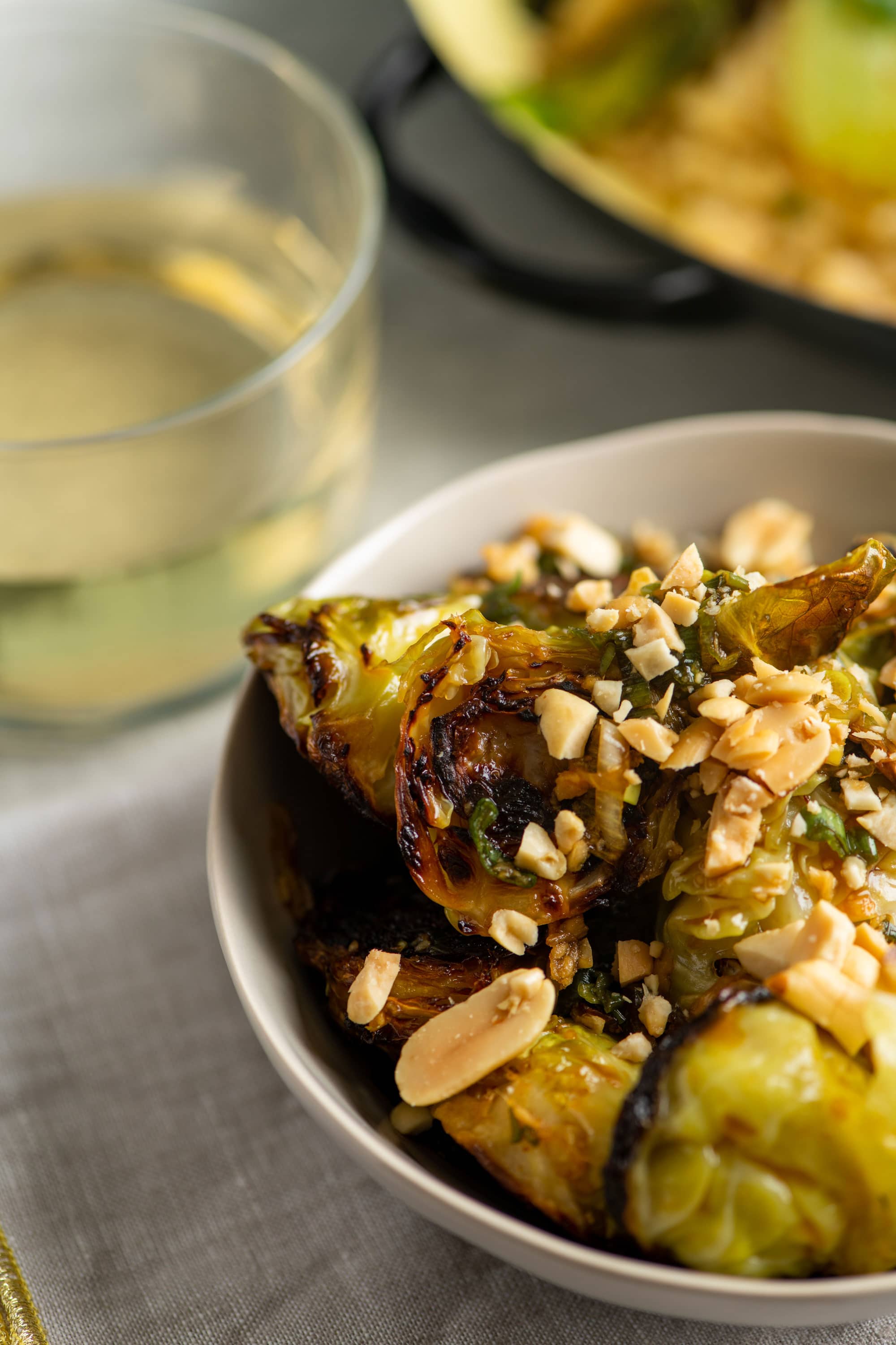 Kung Pao Brussels Sprouts with peanuts in a serving bowl.