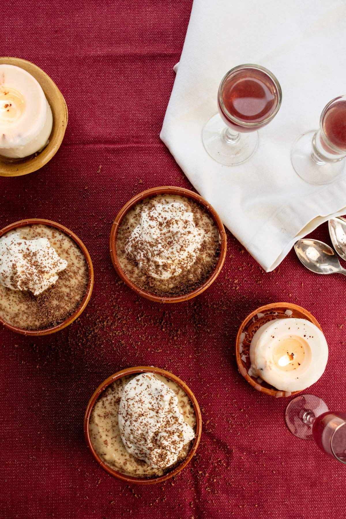 Dessert table setting with bowls of homemade butterscotch pudding.