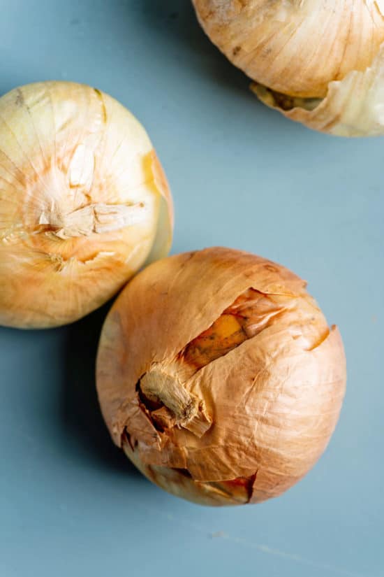 Blue table with three Vidalia Onions.