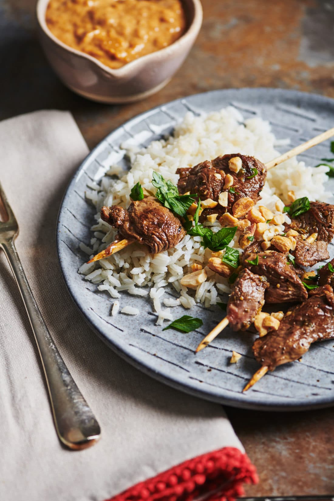 Three Lamb Satay skewers over rice.