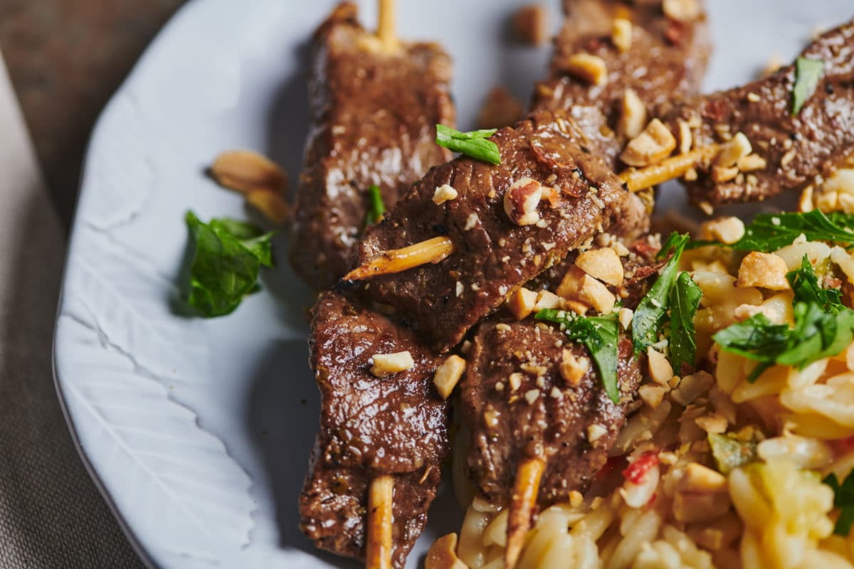 Pile of three skewers of Lamb Satay.