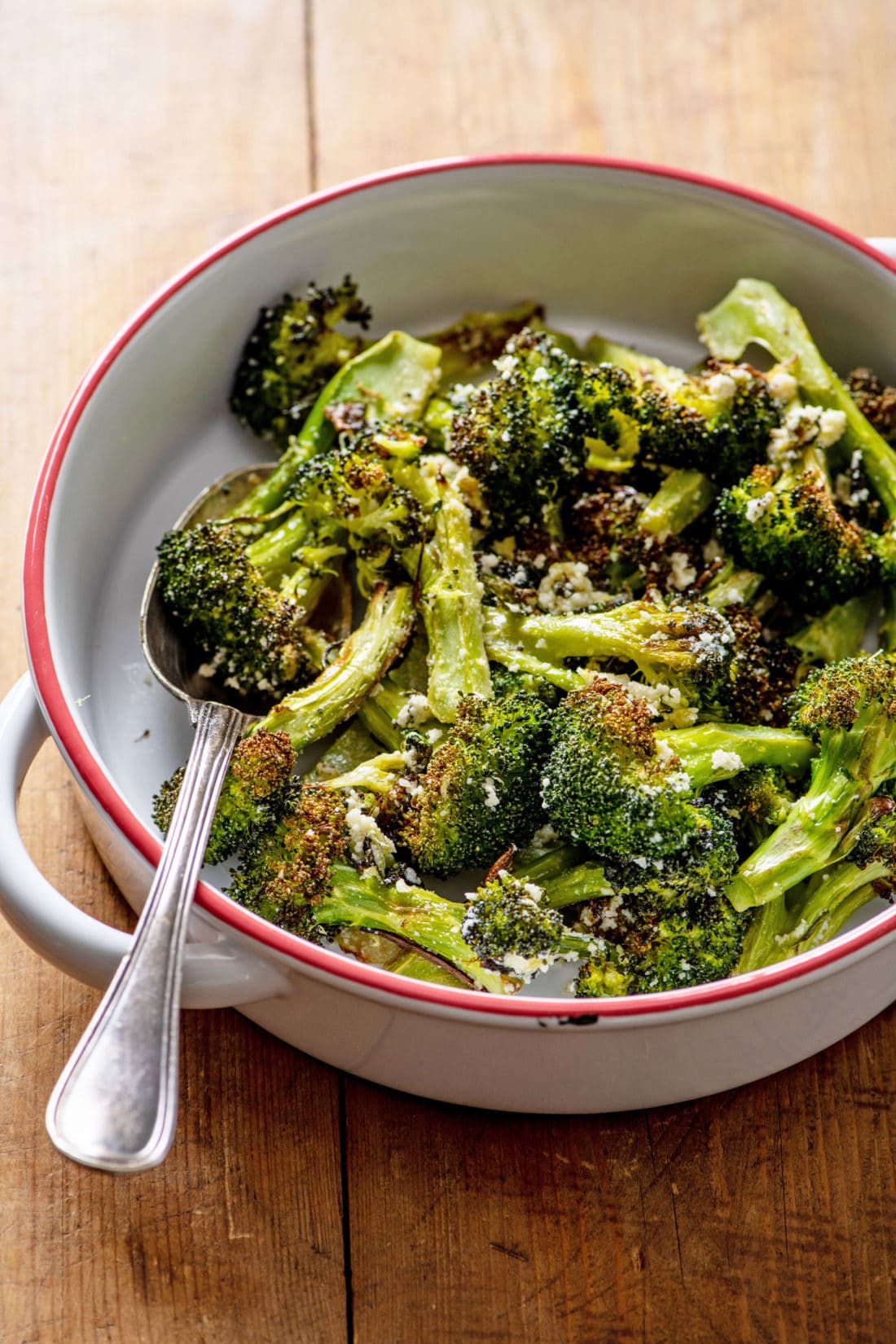 Spoon in a bowl of Parmesan Roasted Broccoli.