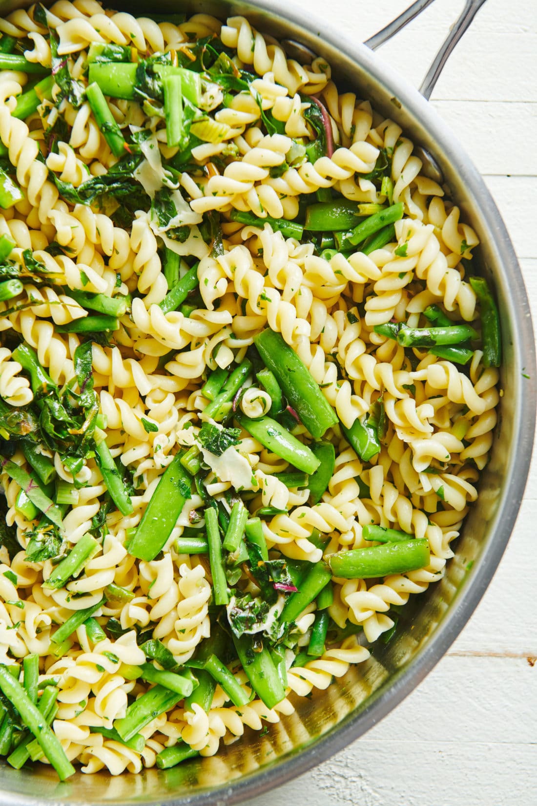 Lemony Rotini with Goat Cheese Sauce and Spring Vegetables in a skillet.