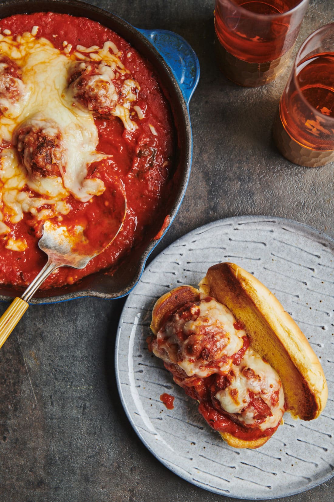 Meatball Sub next to a pan of meatballs.