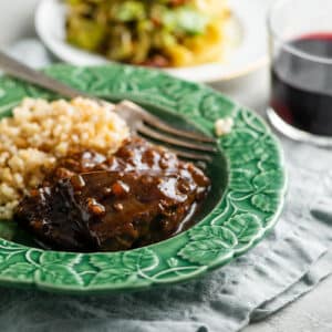 Slow Cooker Teriyaki Beef Tip Steaks in green bowl with couscous.