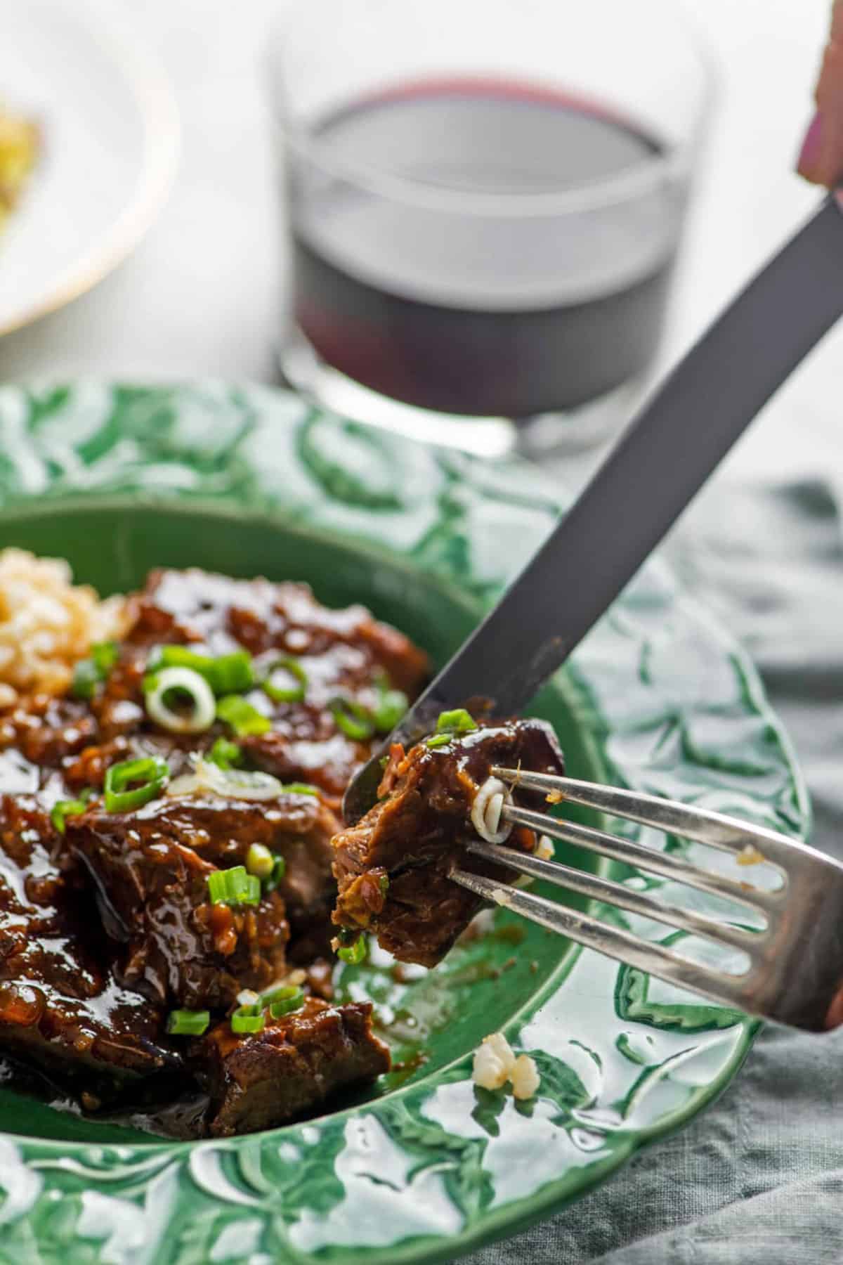 Fork and knife grabbing a Teriyaki Beef Tip Steak.