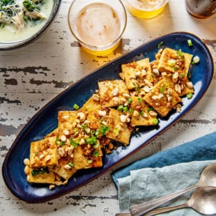 Spicy, Sweet and Nutty Tofu on a long blue platter.
