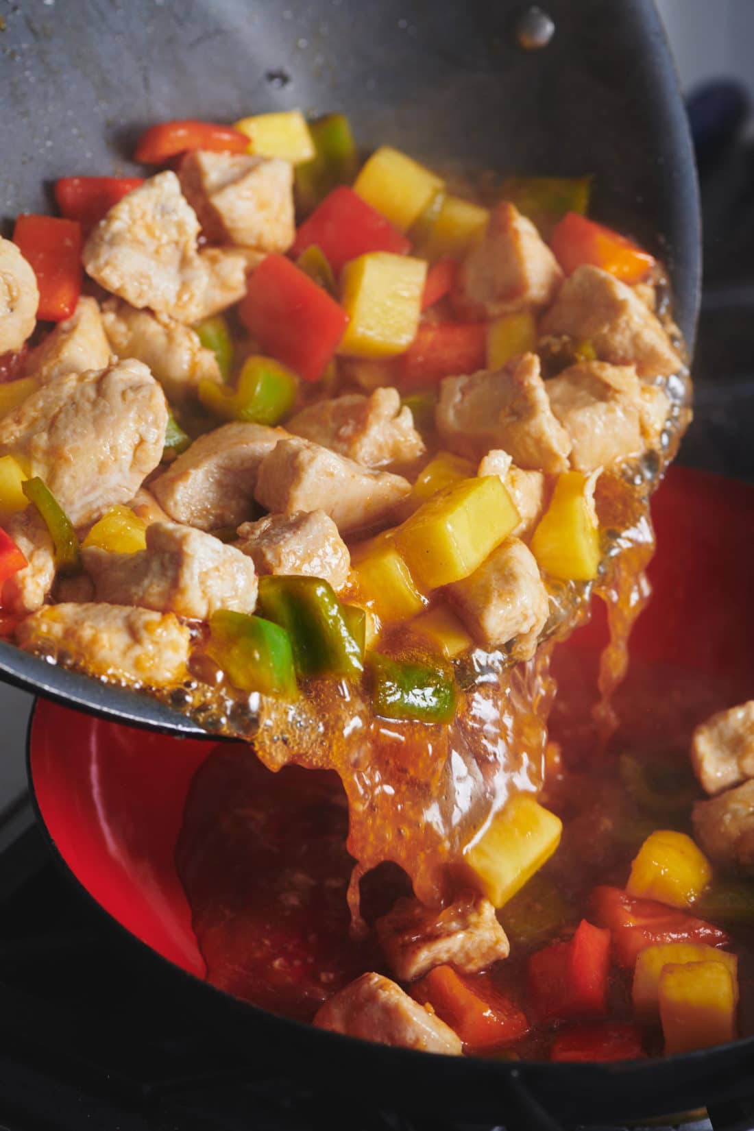 Sweet and Sour Chicken pouring from a pan into a dish.