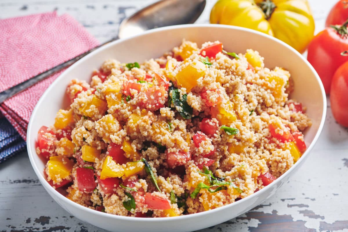 White, oblong bowl of Tomato Bruschetta Couscous.