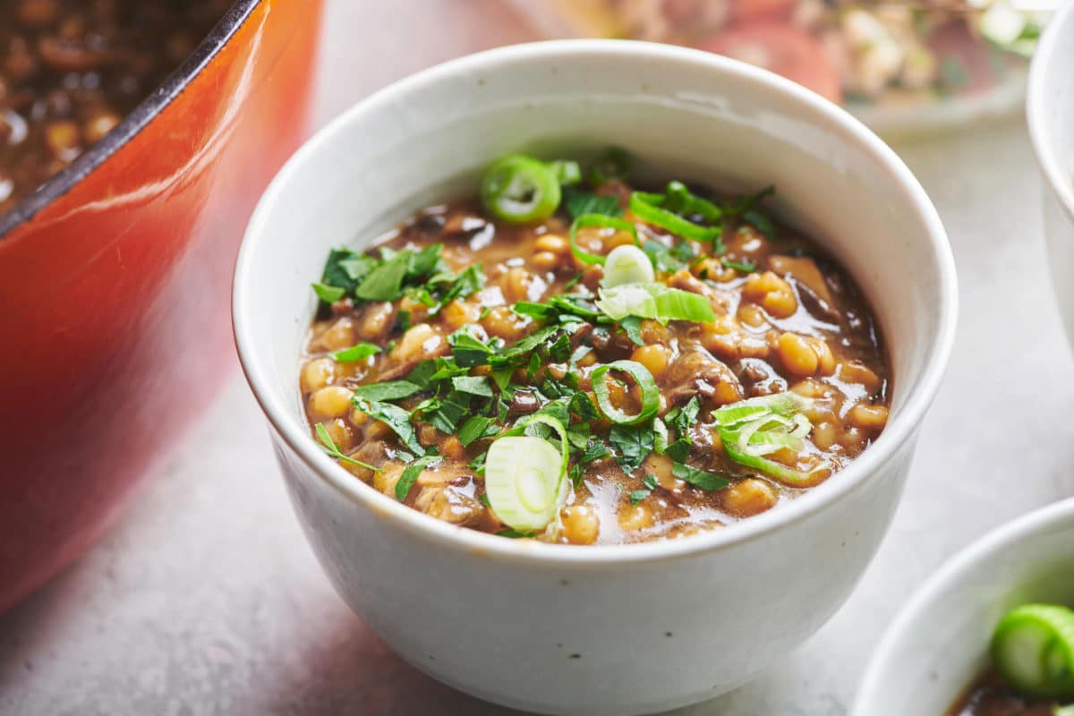 Bowl of Mushroom Barley Soup topped with green onions.