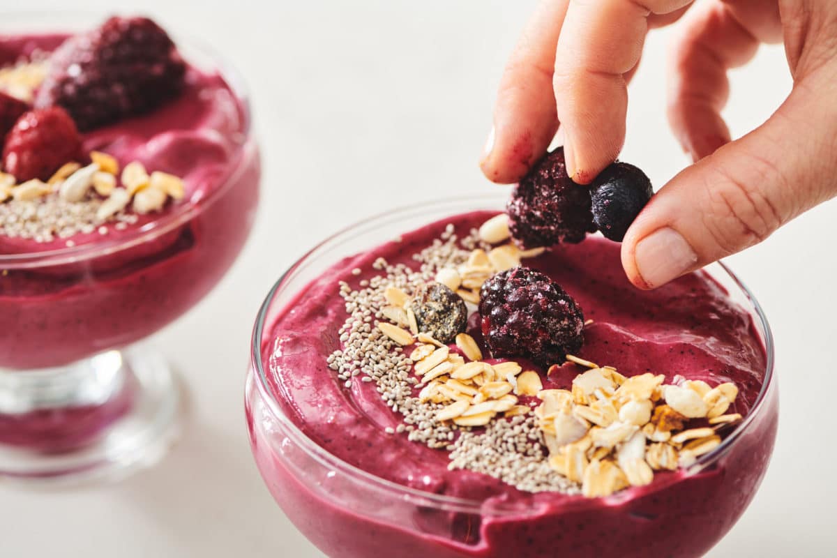 Beet Berry Smoothie Bowl being topped with berries.