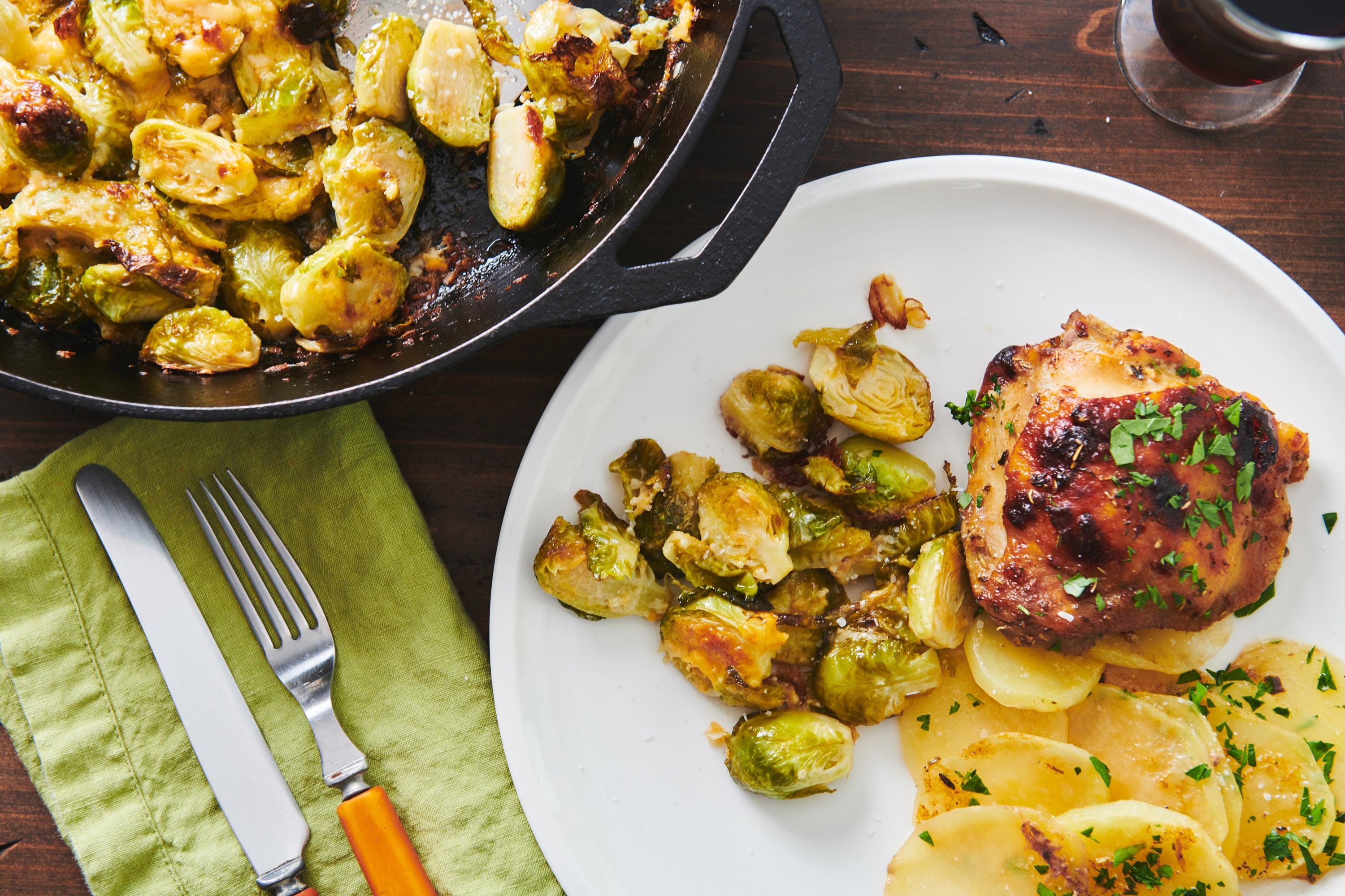 Plate of potatoes,chicken thighs, and Cheesy Baked Brussels Sprouts.