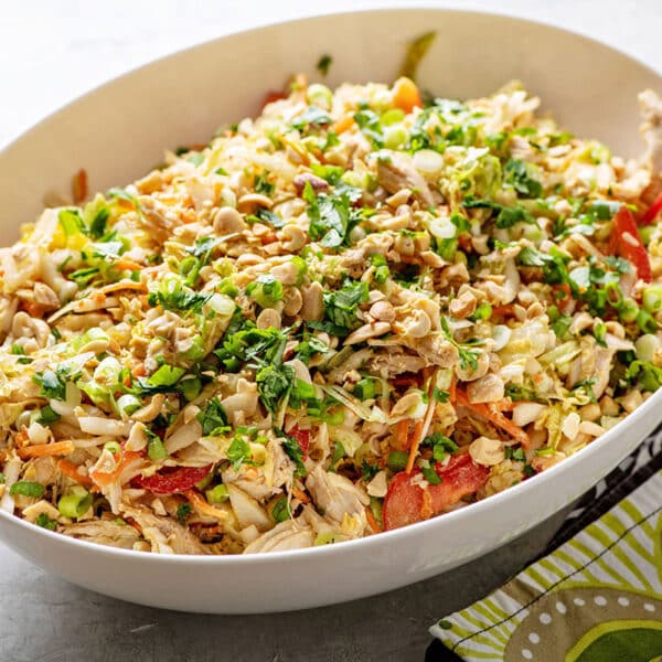 Indonesian Chicken Salad in white serving bowl on table.