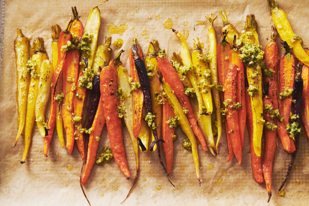 Roasted Carrots with Tapenade Dressing on parchment paper.