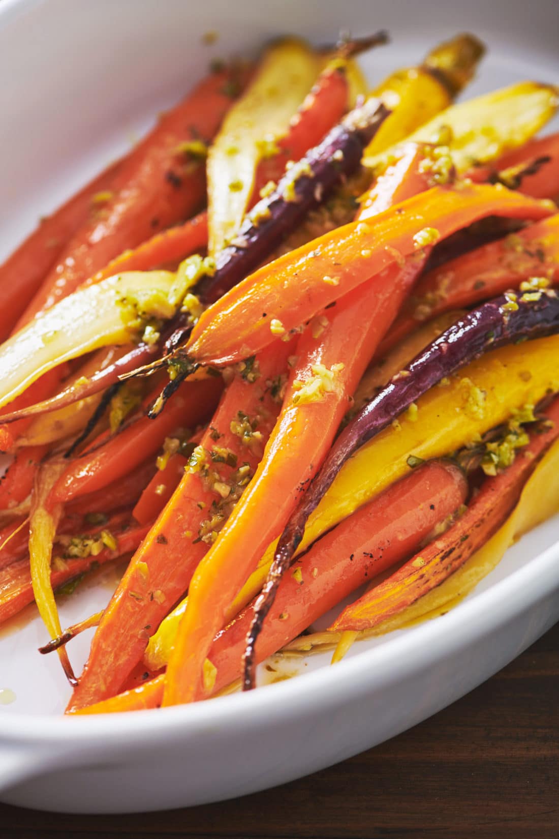 Roasted Carrots with Tapenade Dressing in a white bowl.