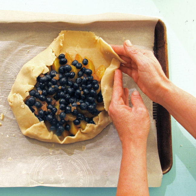 Folding over the pastry edges for a galette or crostada