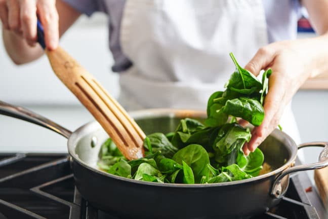 Add spinach to the pan in batches