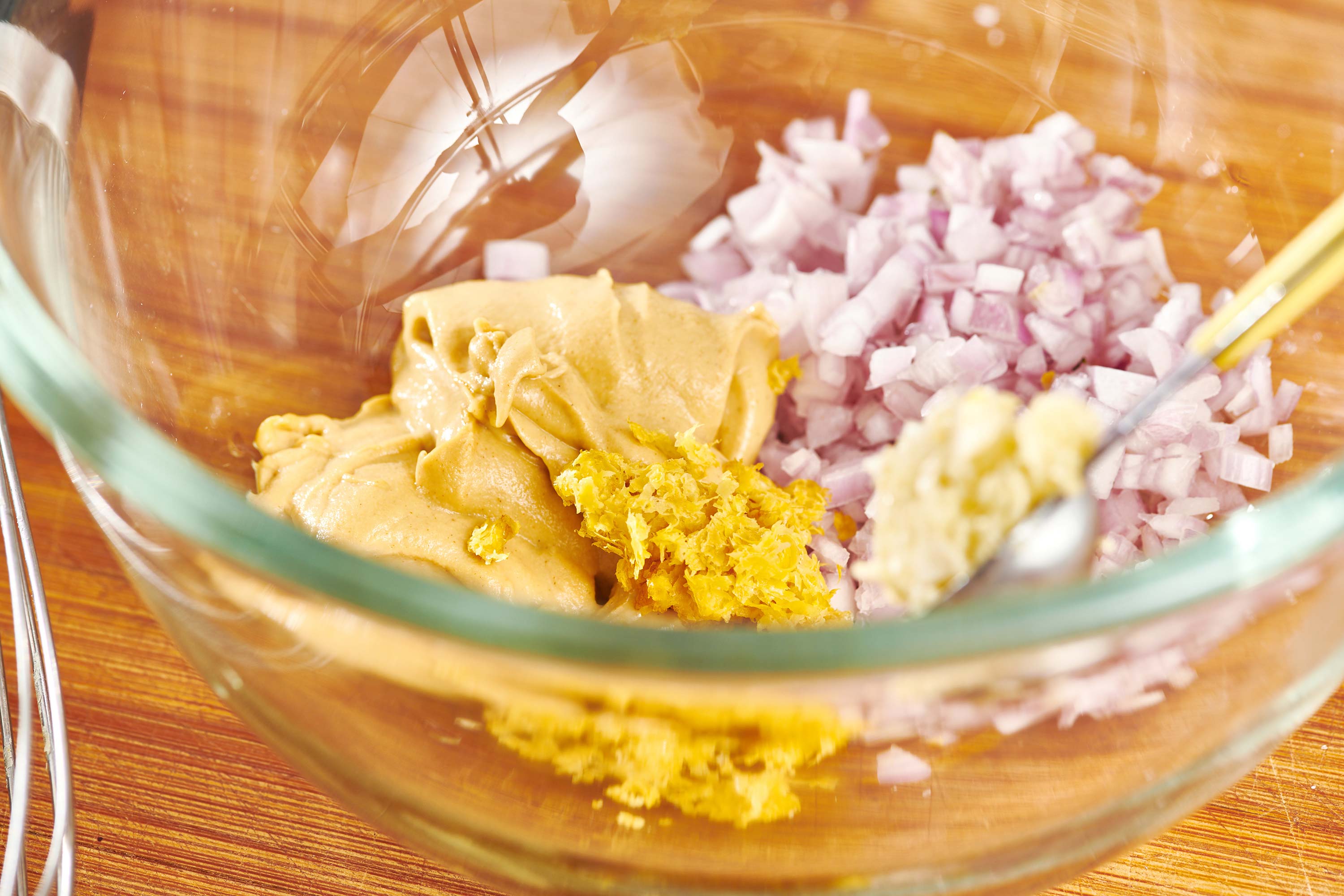 Ingredients for lemon garlic marinade in a glass bowl.