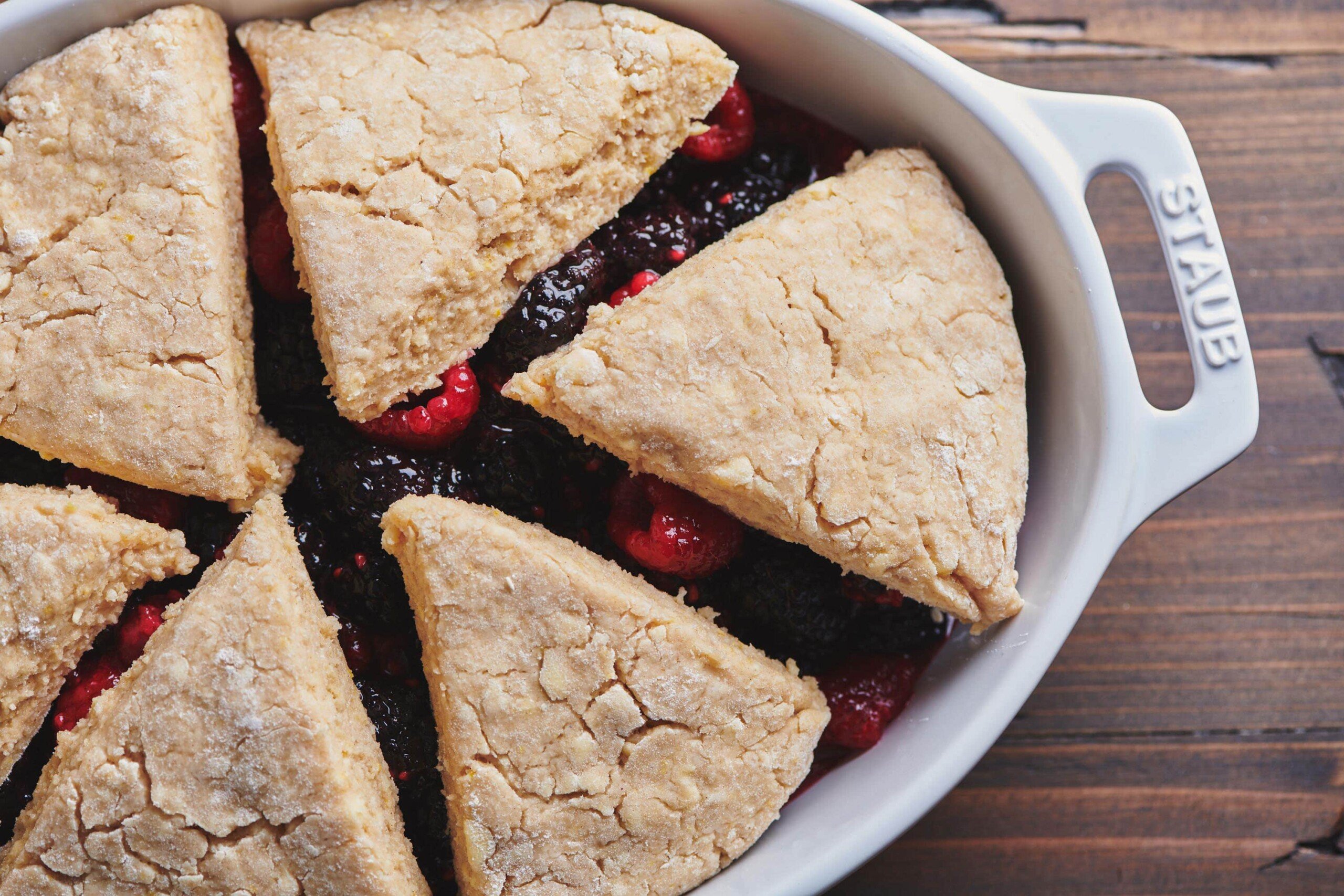 Dough triangles on top of Berry Cobbler filling.
