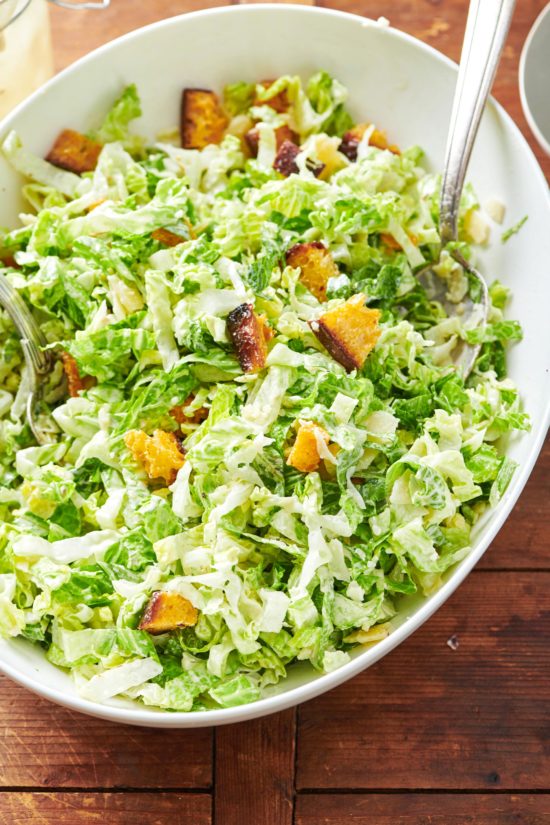 Large white bowl of Caesar Salad with Garlicky Croutons.