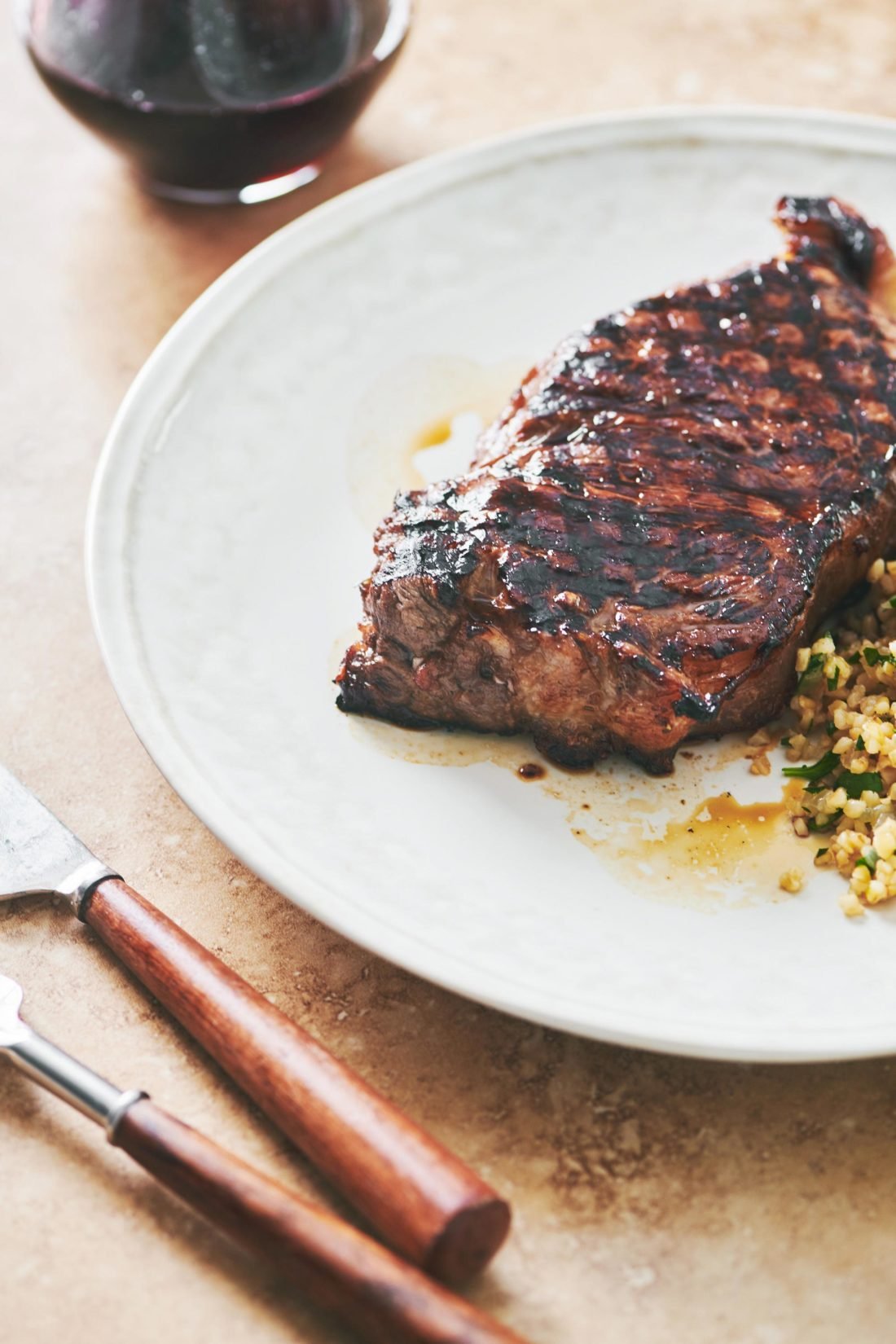 Grilled Marinated NY Strip Steak on a white plate.