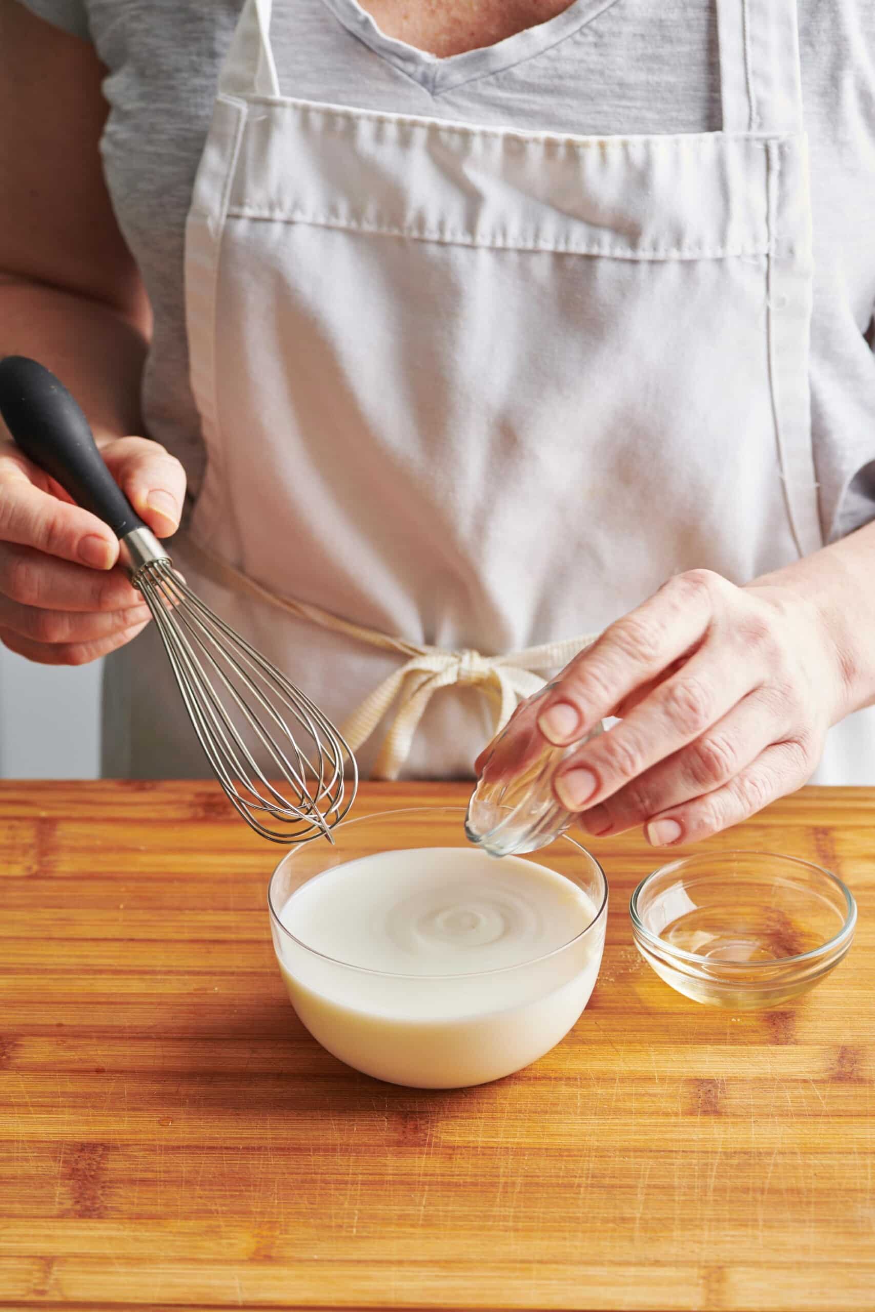Mixing lemon juice into milk to make buttermilk