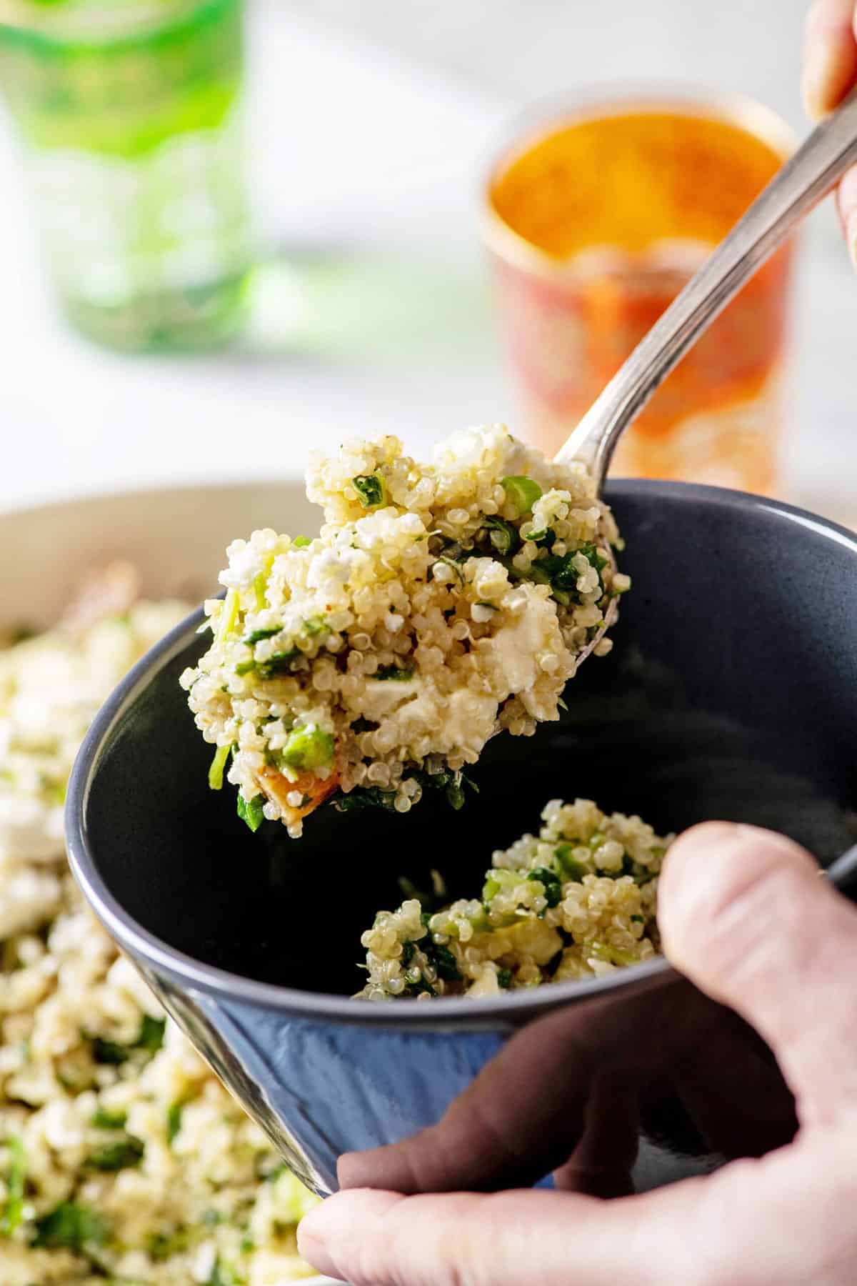 Kale Quinoa Salad with Honey, Lemon and Dijon Dressing in large white serving dish with spoon.