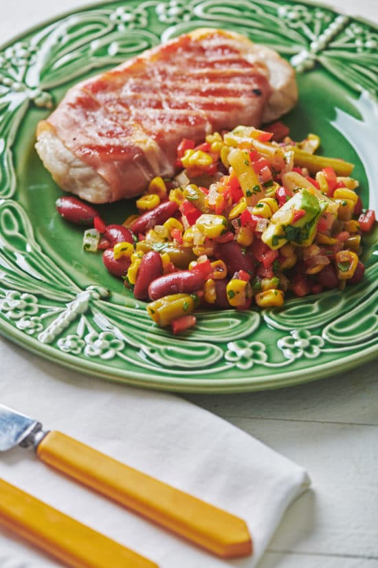 Plate with meat and Mexican Avocado, Corn and Three Bean Salad.