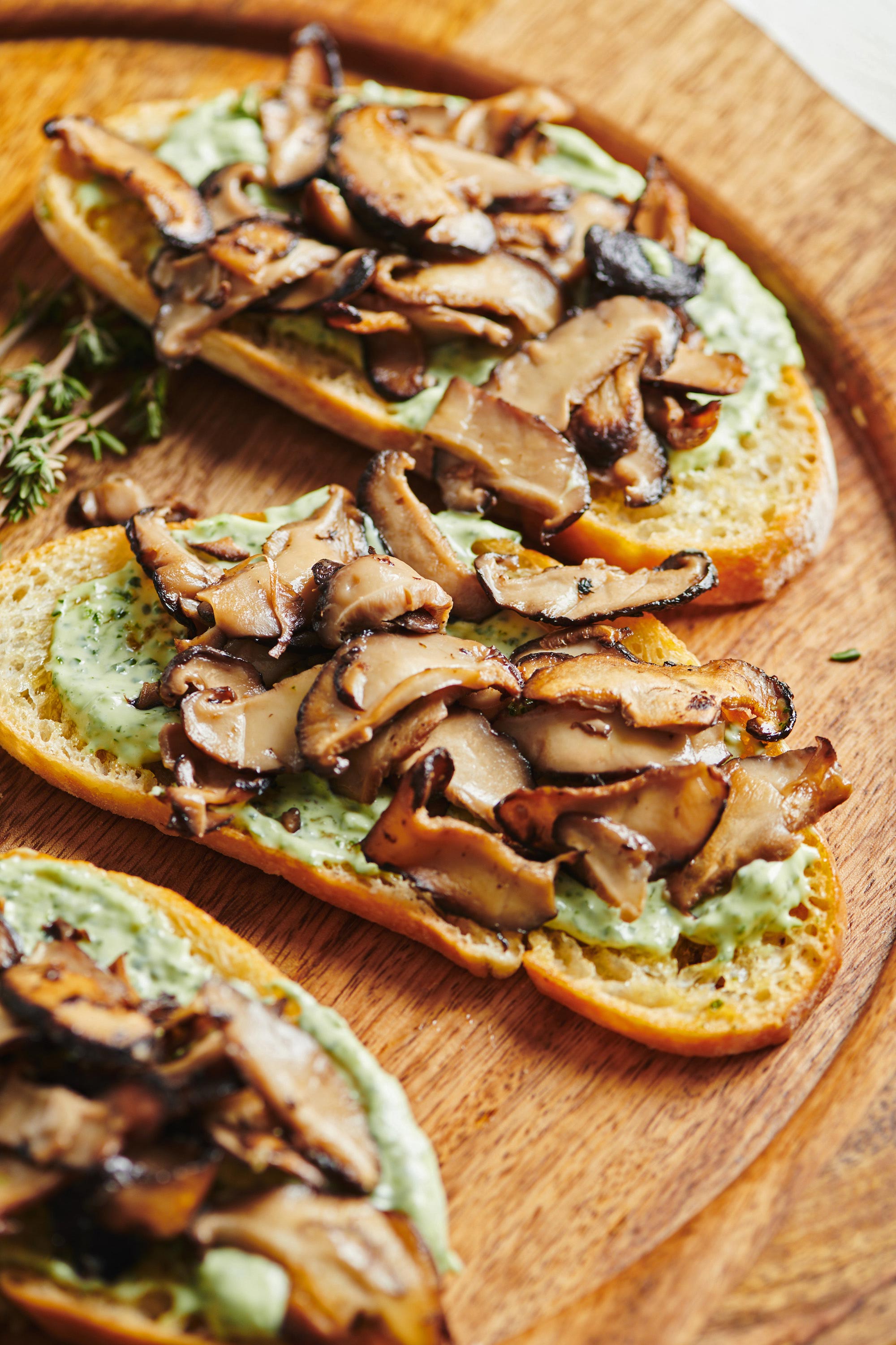 Mushroom Bruschetta with Herbed Mayonnaise on a wooden plate.