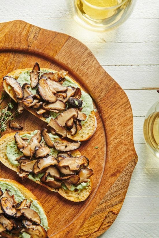 Mushroom Bruschetta with Herbed Mayonnaise on a wooden plate.