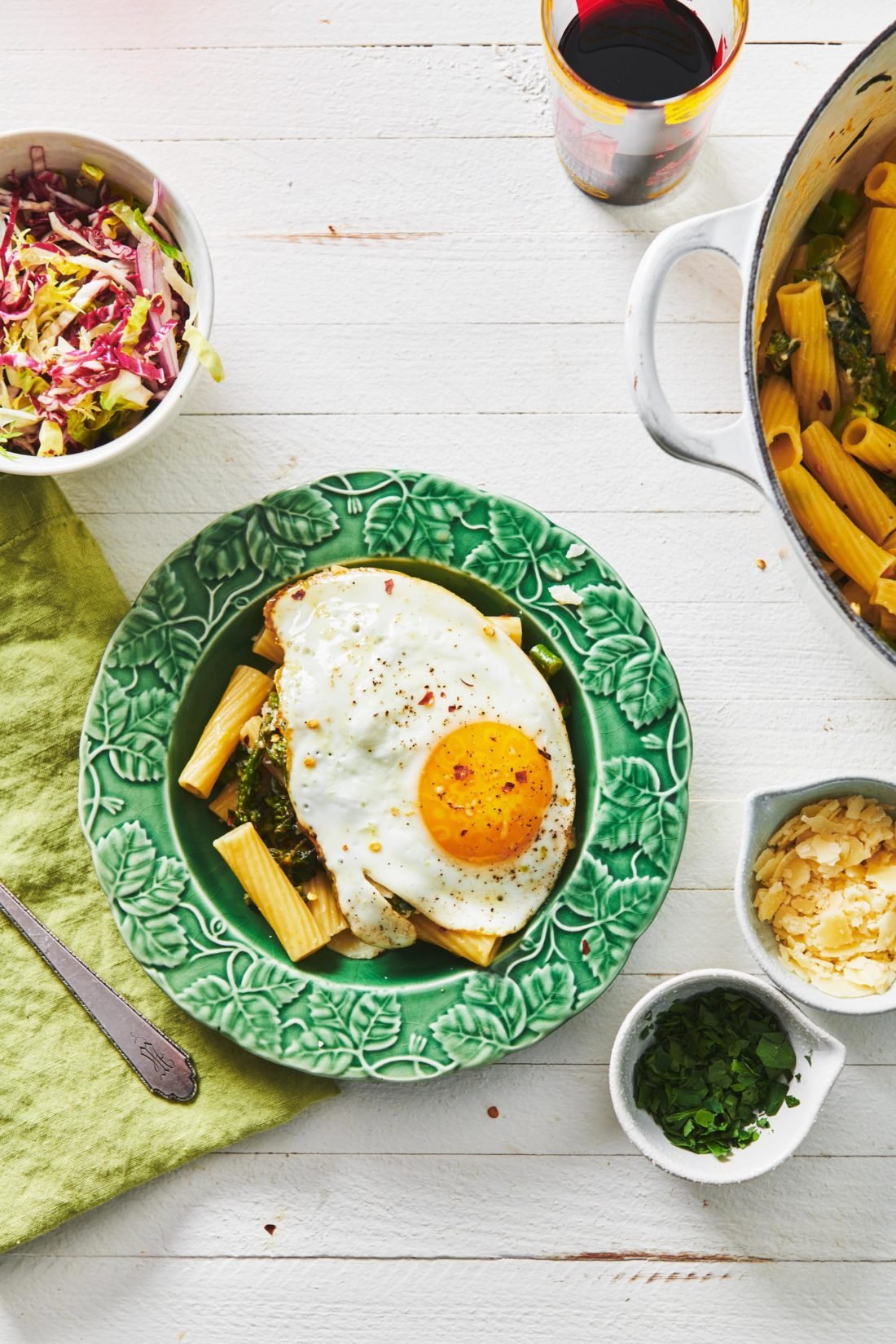 Plate of Pasta with Feta and Broccolini topped with an egg.