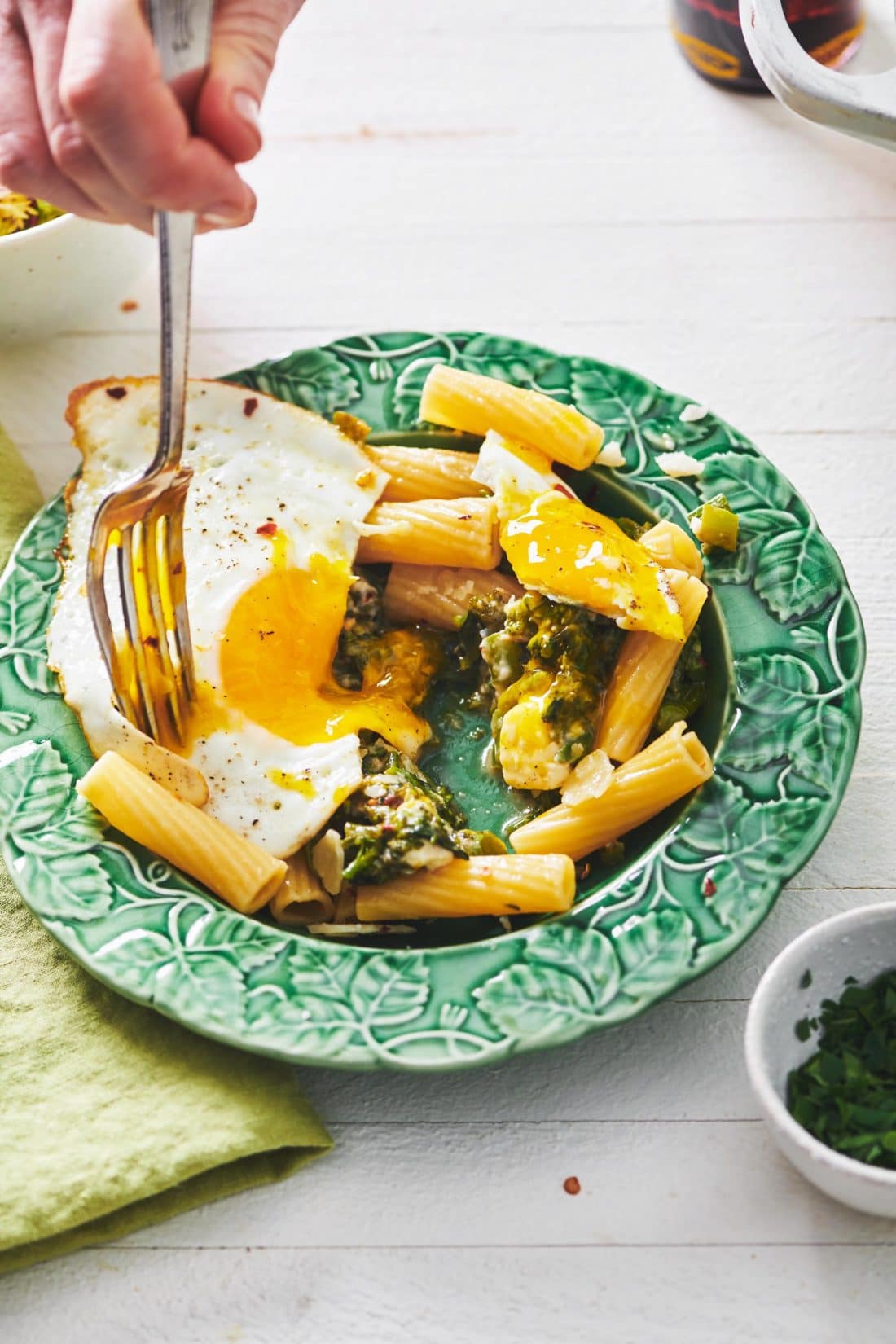 Fork in a fried egg over Pasta with Feta and Broccolini.
