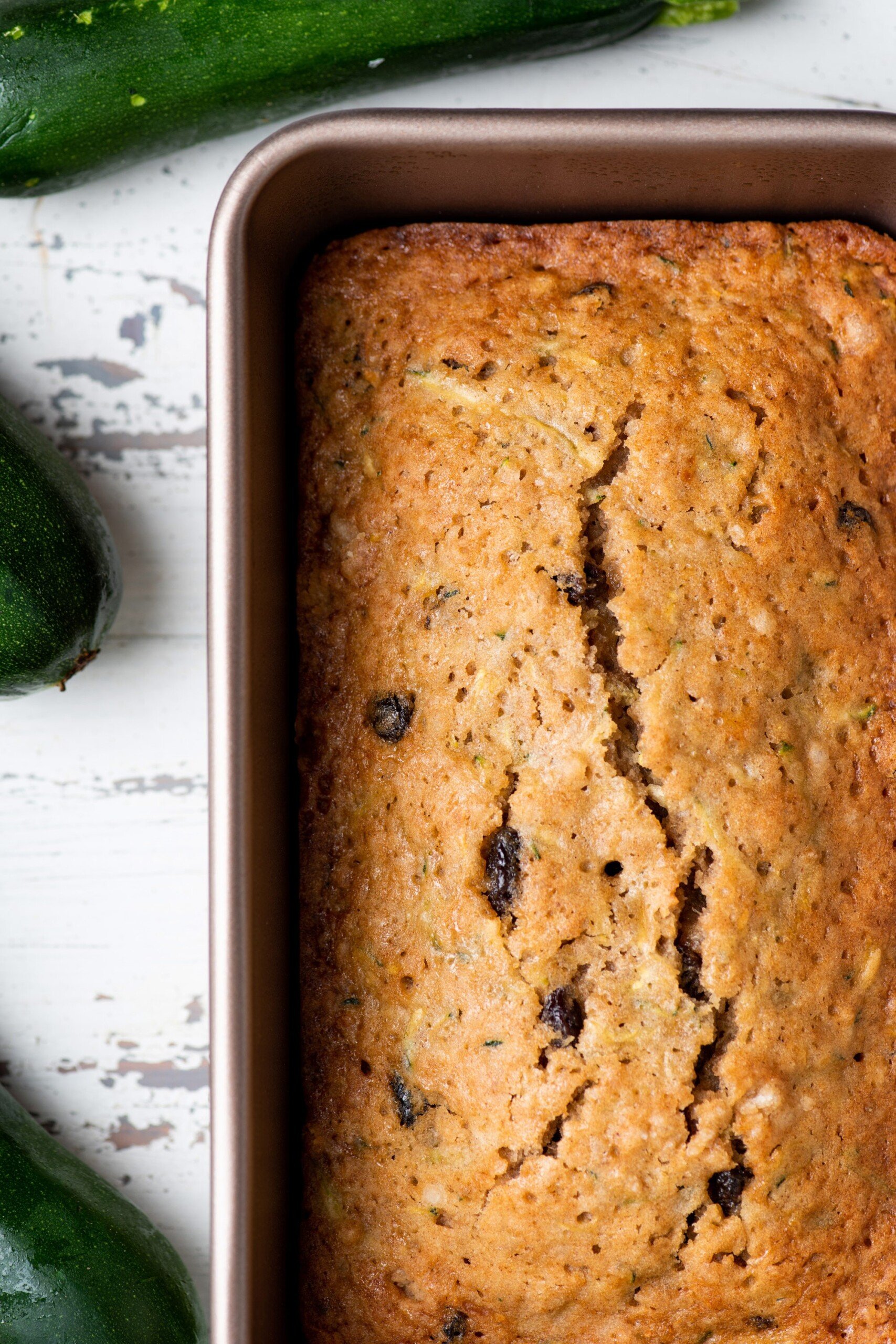 Classic Zucchini Bread with raisins in loaf pan.