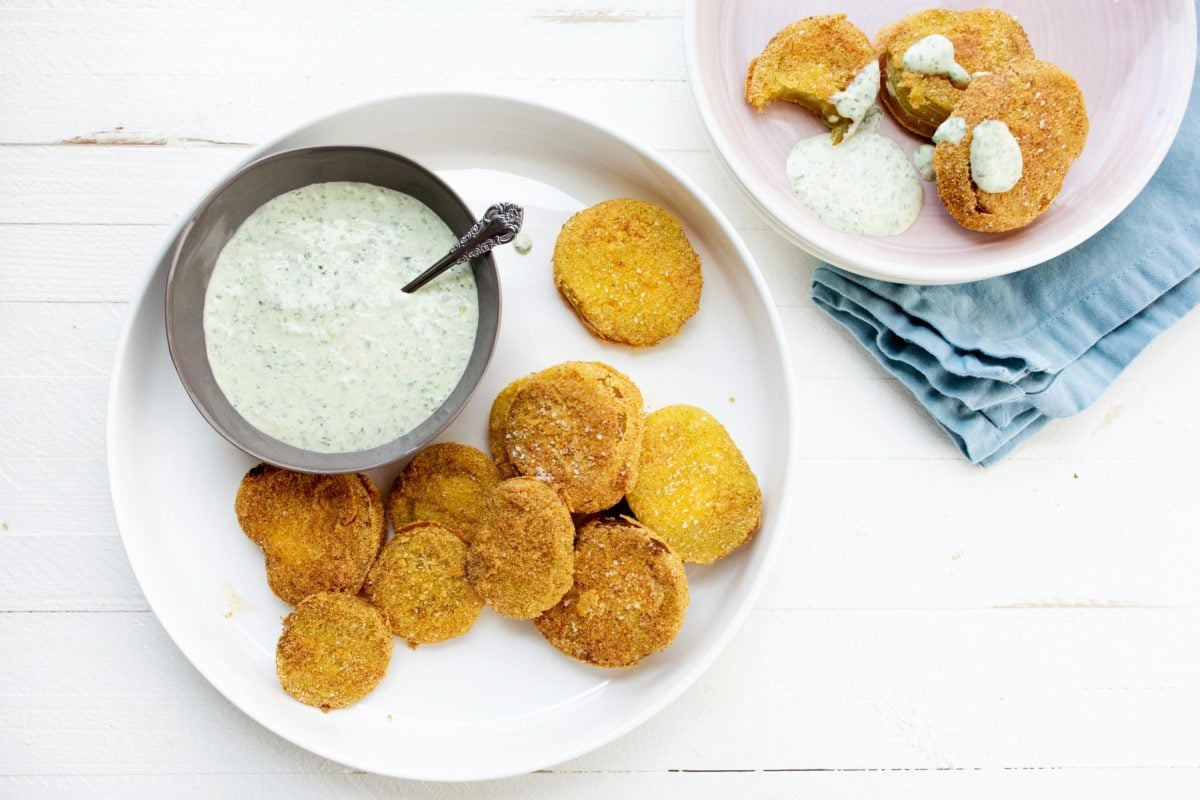 Plates with Fried Green Tomatoes and Green Goddess Dressing.