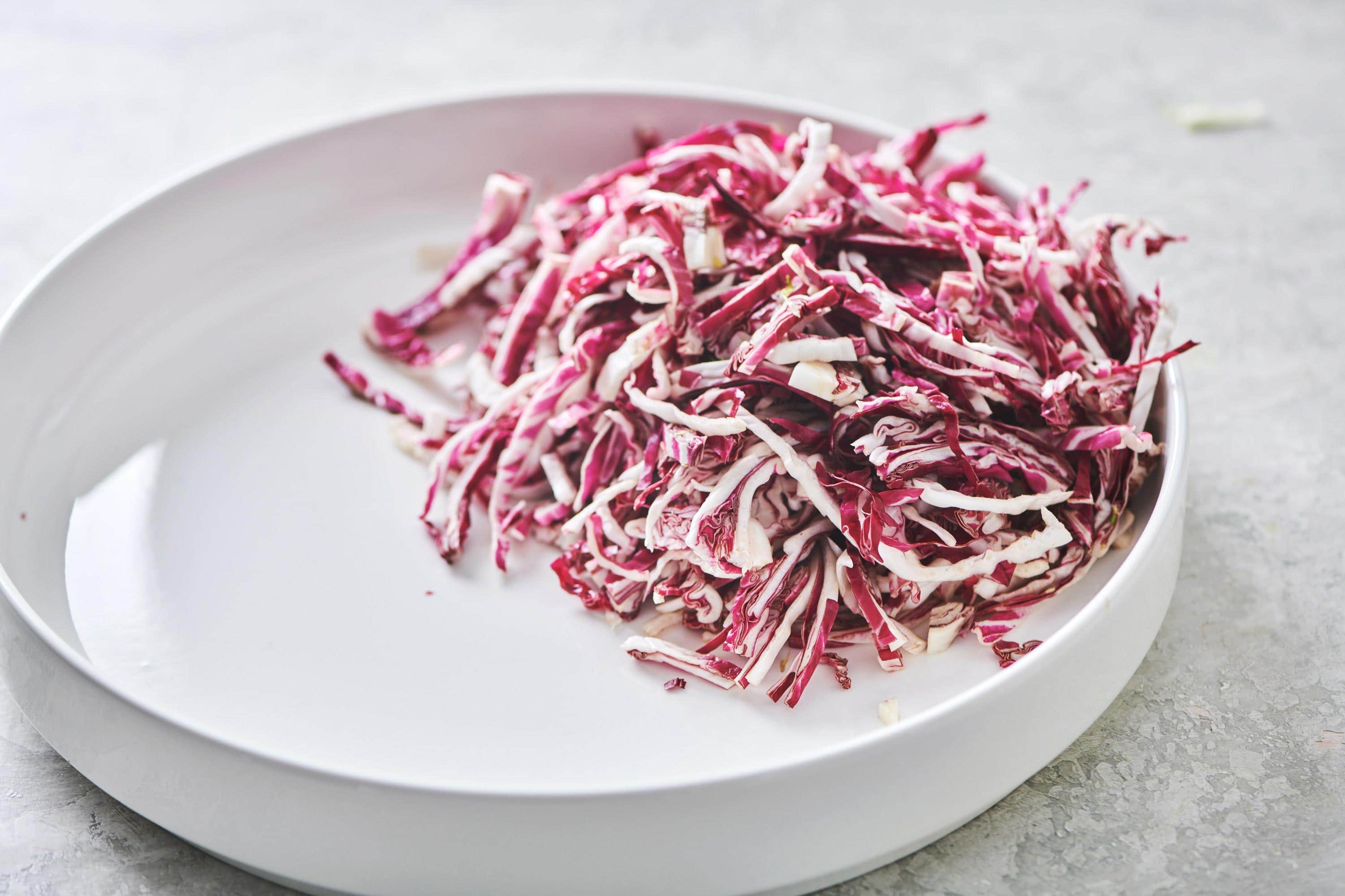 White plate with thin slices of radicchio.