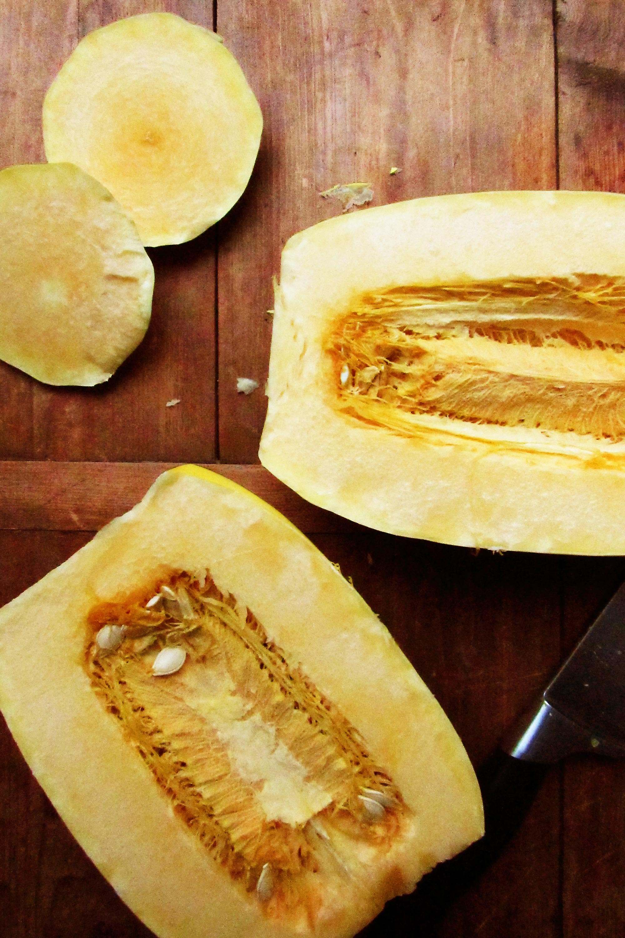 Halved spaghetti squash on a wooden surface.